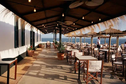 Sunset terrace and cocktails at Artrutx Sea Club by Cap d'Artrutx lighthouse