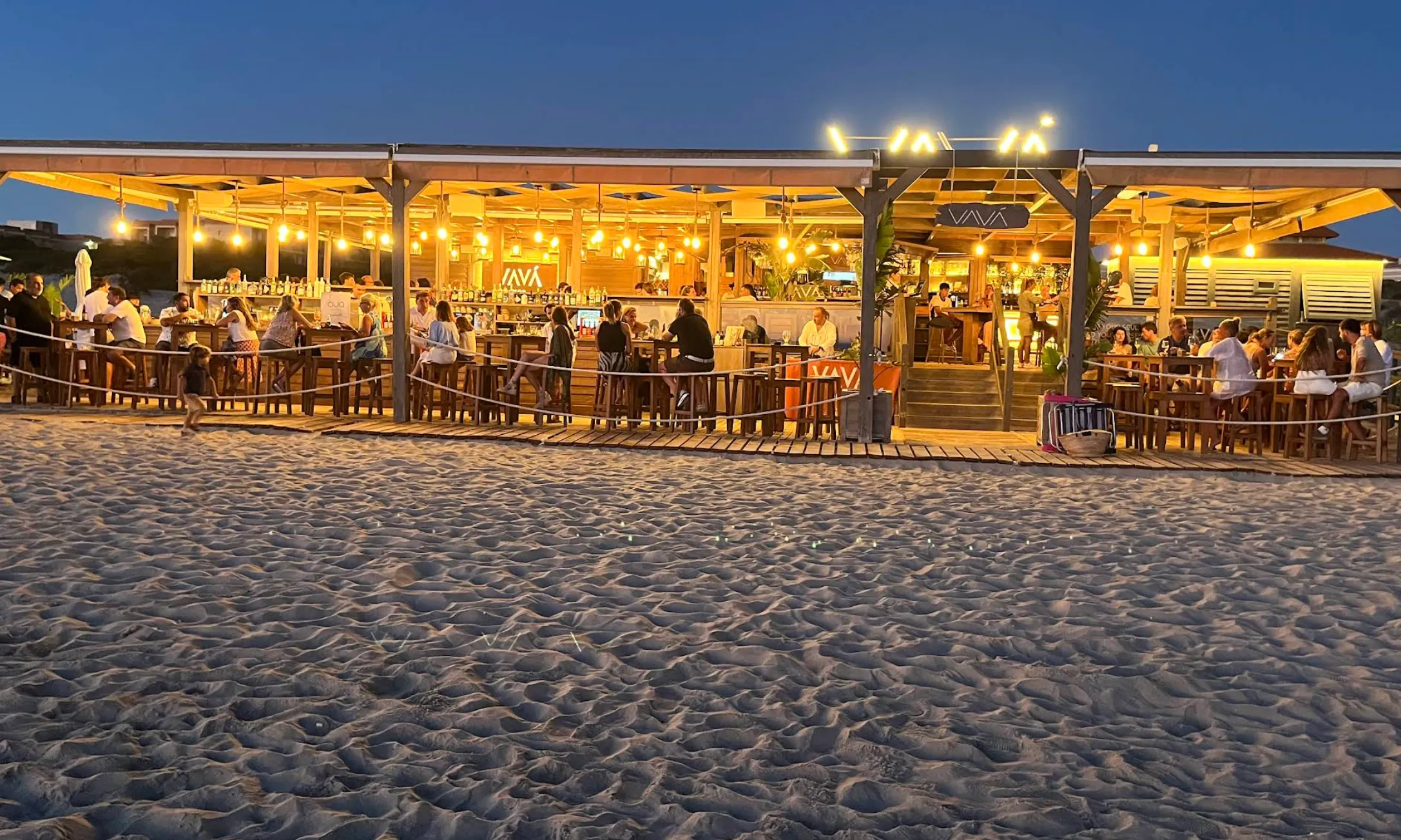 Beachfront dining and daybeds at VAVÁ Playa La Barrosa