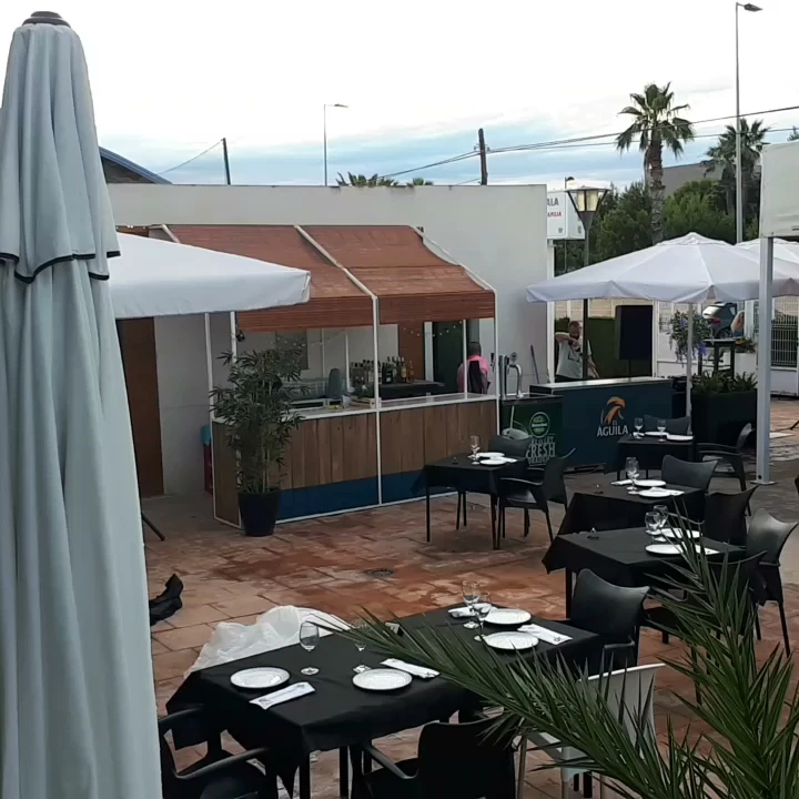 Outdoor seating and sunbeds at Impala Beach Club on Playa del Pinar